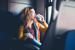 Girl drinking coffee on train